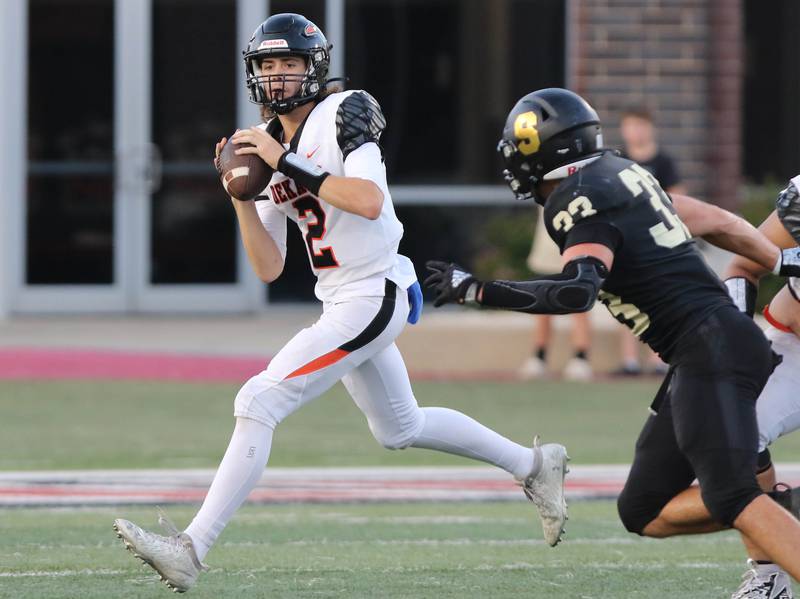 DeKalb's Cole Latimer looks for a receiver during the First National Challenge game Friday, Aug. 25, 2023, in Huskie Stadium at Northern Illinois University in DeKalb.