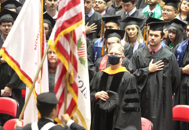 Graduation candidates say the Pledge of Allegiance at the Convocation Center Saturday, May 14, 2022, during the first of two undergraduate commencement ceremonies at Northern Illinois University in DeKalb.