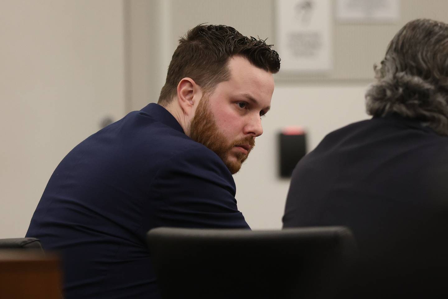 Defendant Sean Woulfe looks to his lawyer during closing arguments on Monday at the Will County Courthouse. Sean Woulfe, 29, is charge with reckless homicide of Lindsey Schmidt, 29, and her three sons, Owen, 6, Weston, 4, and Kaleb, 1. Monday, Mar. 28, 2022, in Joliet.