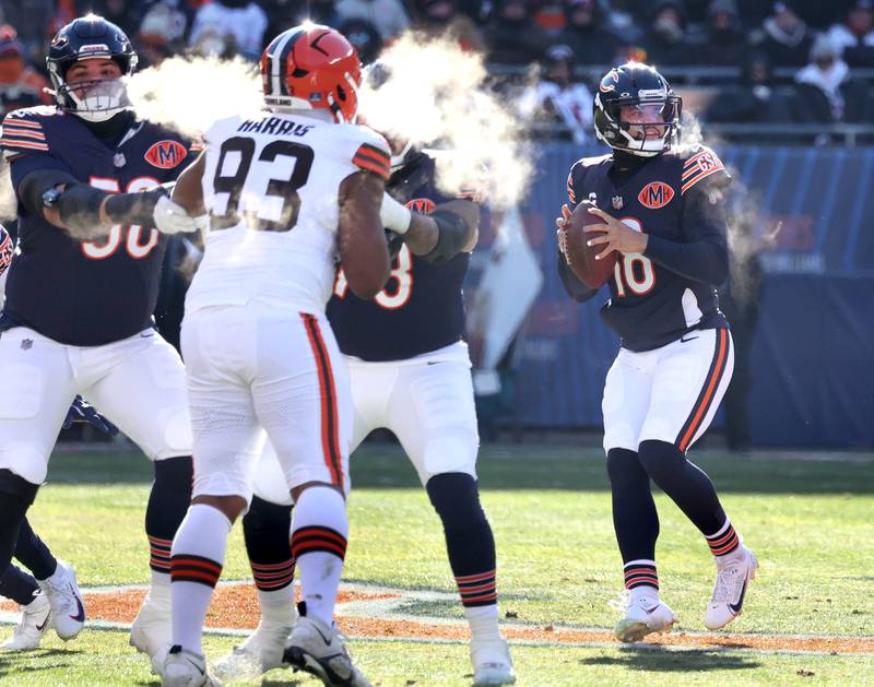 Chicago Bears quarterback Caleb Williams looks for a receiver as the offensive line holds off the Cleveland Browns pass rush during their game Sunday, Dec. 14, 2025, at Soldier Field in Chicago.