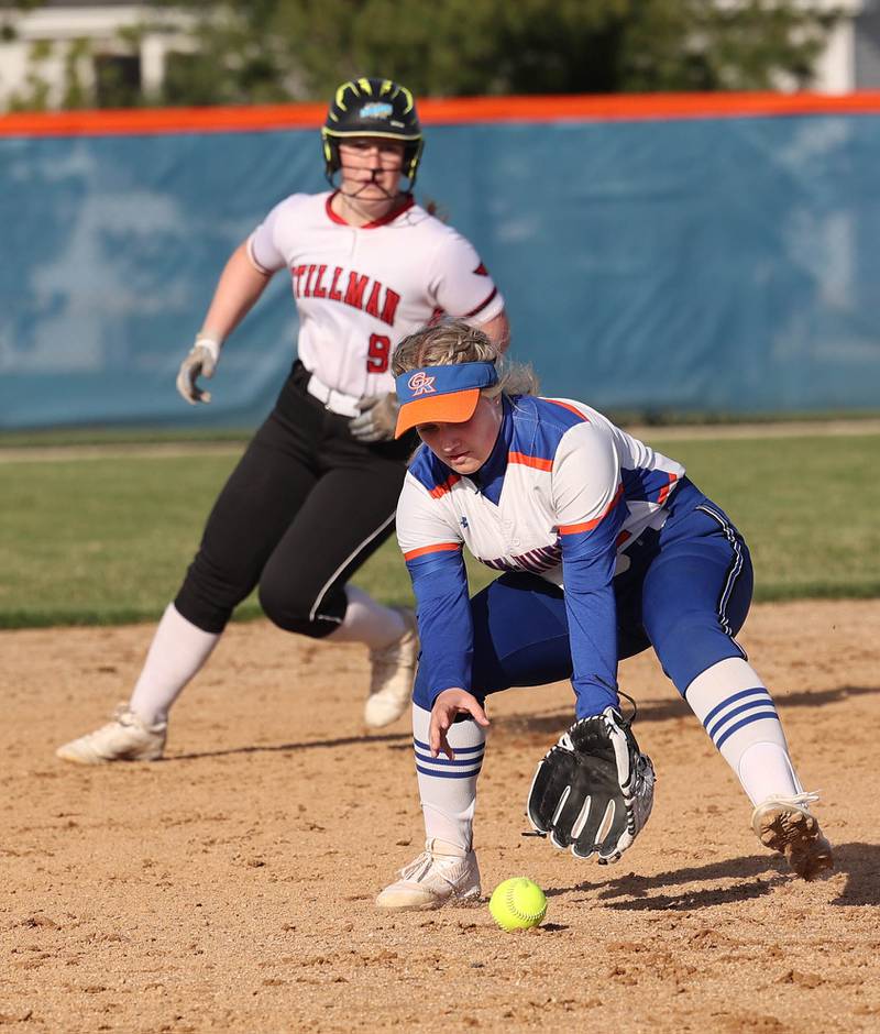 Genoa-Kingston's Reagan Tomlinson picks up a ball after it deflected off a teammate as Stillman Valley's Ellie Bussan rounds second base during their game Tuesday, April 18, 2023, at Genoa-Kingston High School.