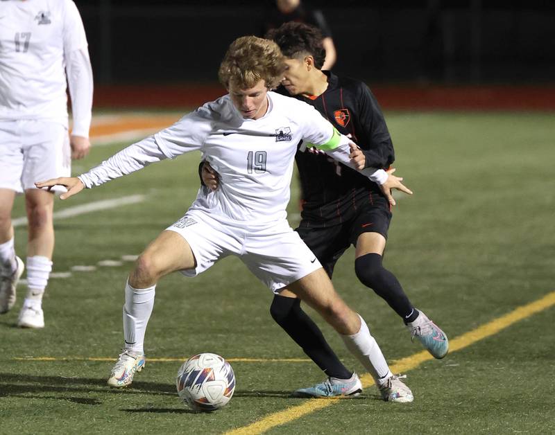 Kaneland's Michael Happ tries to hold off DeKalb's Erick Talamantes during their game Thursday, Oct. 12, 2023, at DeKalb High School.