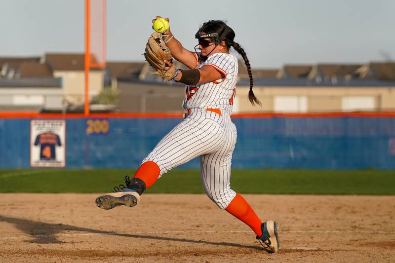 Oswego’s Aubriella Garza (12) delivers a pitch against Minooka during a Southwest Prairie Conference softball game at Oswego High School on Wednesday, April 23, 2025.