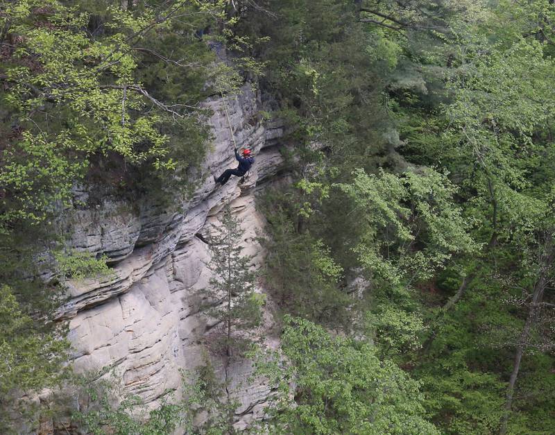 A firefighter climbs down the side of a cliff during rope rescue training on Saturday, May 2, 2026 in Wildcat Canyon at Starved Rock State Park.