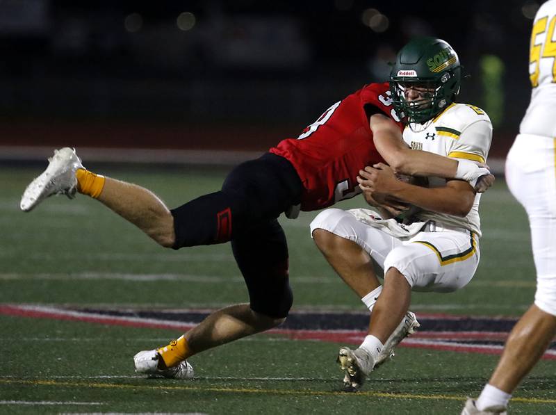 Huntley's Benjamin Wean sacks Crystal Lake South's Caden Casimino during a Fox Valley Conference football game on Friday, Sept. 29, 2023, at Huntley High School.