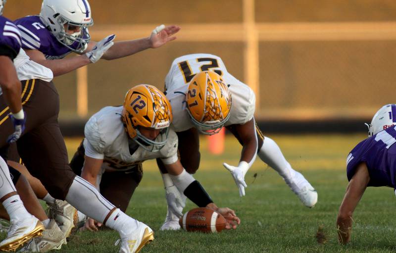 Jacobs’ Connor Goehring, left, and Mike Cannady cover a loose ball in varsity football on Friday, Sept. 6, 2024, at Hampshire School in Hampshire.