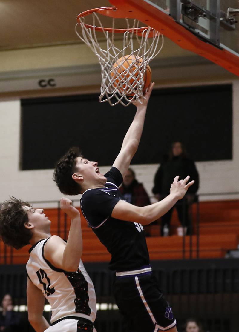 Hampshire's Sean Roth  shoots a layup in front of Crystal Lake Central's Michael Shanahan during a Fox Valley Conference basketball game on Friday, Feb. 7, 2025, at Crystal Lake Central High School.