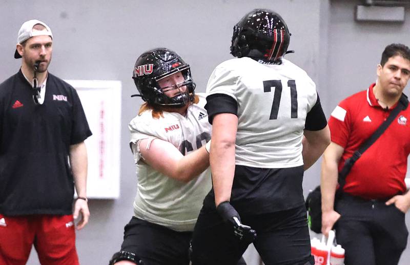 Northern Illinois offensive linemen Evan Buss (left) and Drew Hoth participate in a drill during the teams first spring practice Wednesday, March 22, 2023, in the Chessick Practice Center at Northern Illinois University in DeKalb.