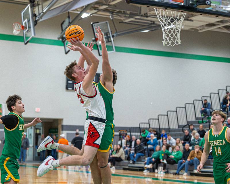 Chevy Langham (23) of Hall lays ball up as Zeb Maxwell (35) of Seneca attempts to block shot during game in the Shipyard Showdown on Tuesday, December 23, 2025 at Seneca High School in Seneca.