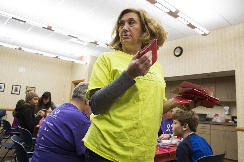 Liisa Seuser helps organize cards on Monday, Jan. 21, 2019, during the MLK Day of Service at Joliet Area Community Hospice in Joliet, Ill. Volunteers made over 300 cards.