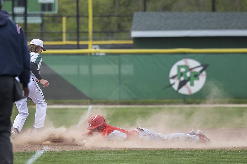 Oregon’s Jack Washburn slides in safely at third for a triple against Rock Falls Tuesday, May 2, 2023.