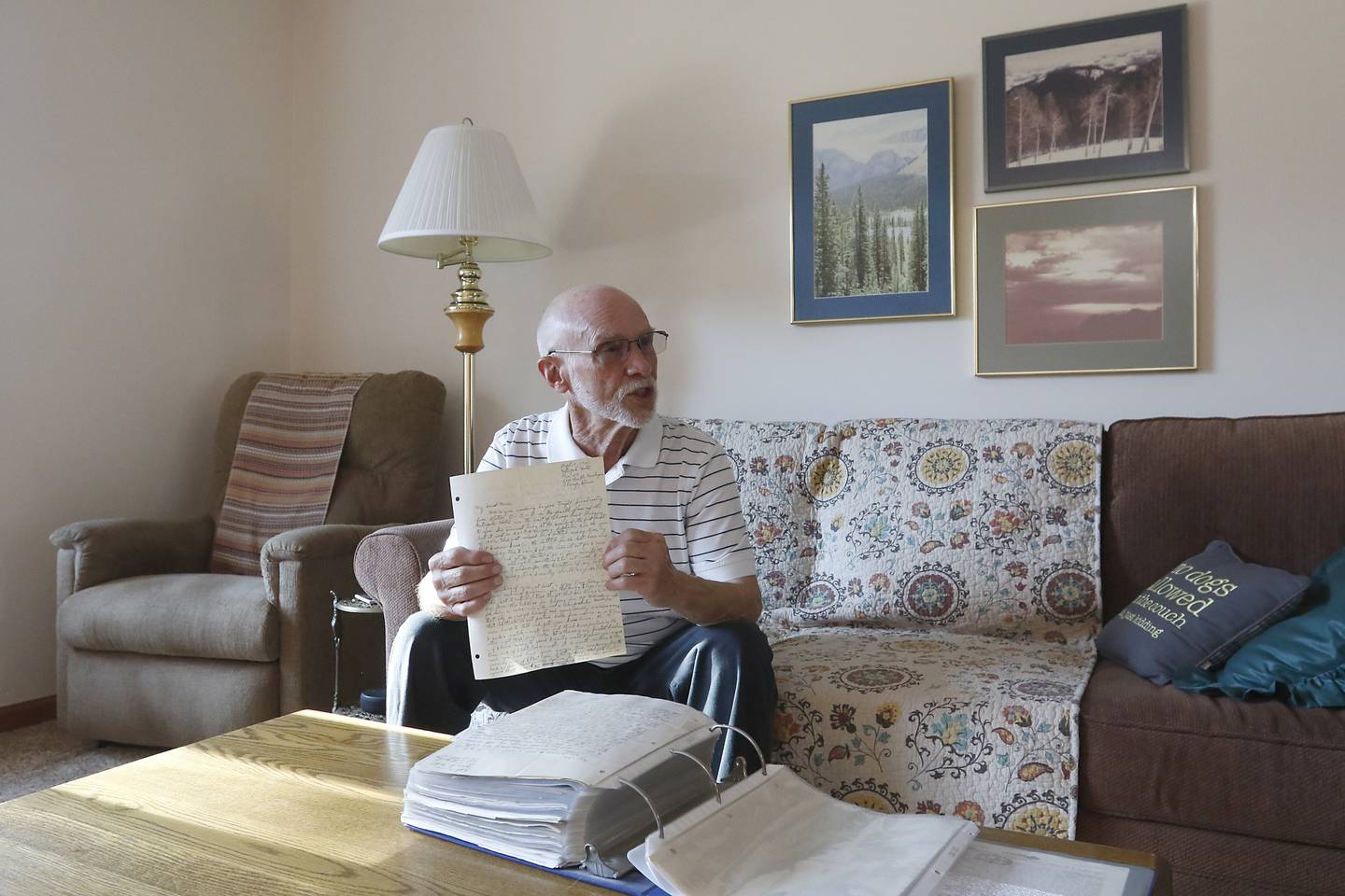 Art Peterson holds one of the letters his father, U.S. Army Air Forces Staff Sgt. Robert E. Peterson, wrote to his mother, Marie, during World War II, on Nov. 9, 2022, at his home in Spring Grove. Peterson, a retired journalist, wrote a book based on the letters.