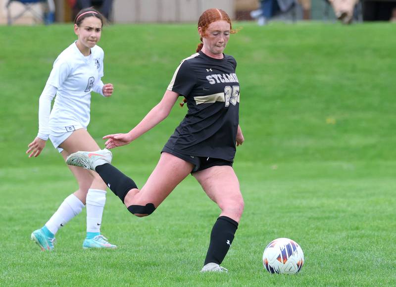 Sycamore's Isabelle Segreti shoots and scores in front of Kaneland's Taylor Mills during their game Wednesday, April 29, 2026, at Sycamore High School.