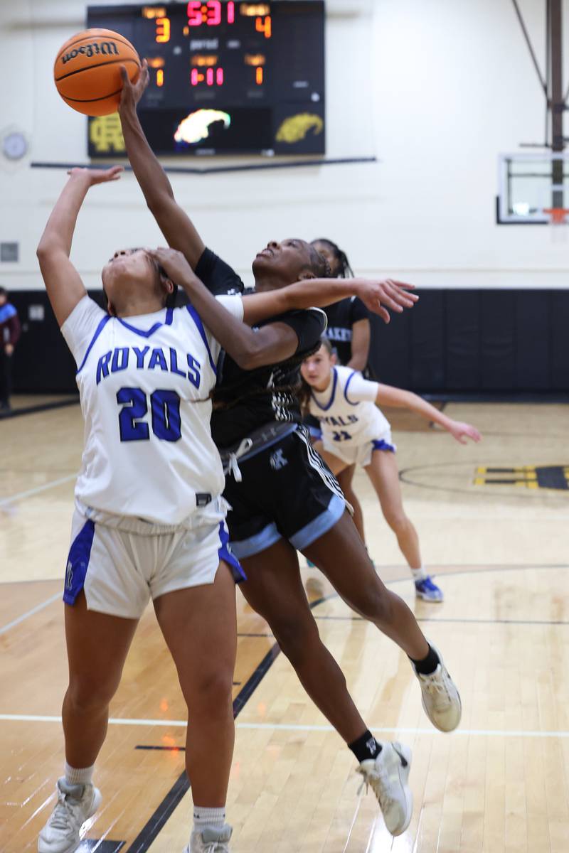 Kankakee's Jasyia Wesby, right, gets a hand on a rebound over Rosary's Kayla Garcia during the Kays' 75-28 victory over Rosary at the Reed-Custer Classic on Monday, Nov. 17, 2025.