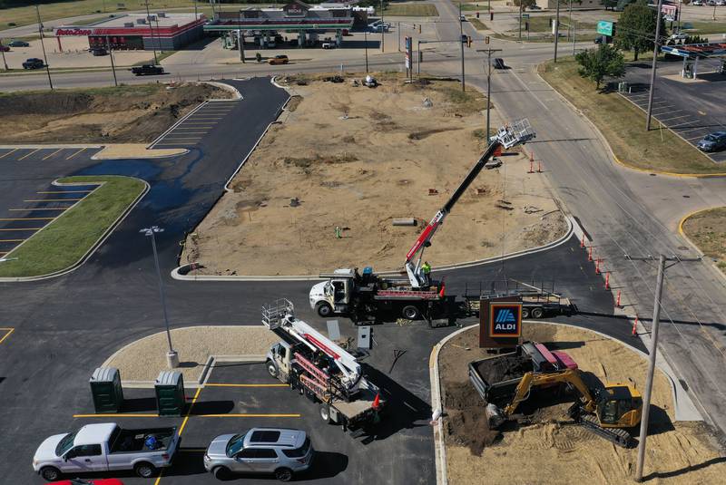 Crews from Doyle Signs, erect Aldi signs on the side of the new store located at the intersection of Backbone and North Main Street on Thursday, Oct. 9, 2025 in Princeton. The store is expected to open next month.