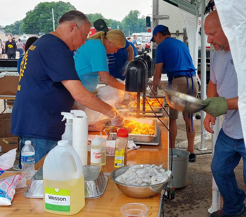 Volunteers for the Princeton Rotary club prepare grilled and fried shrimp baskets for customers Saturday, June 1, 2023, at the ShrimpFest and Brew Hullabaloo at Rotary Park in Princeton.
