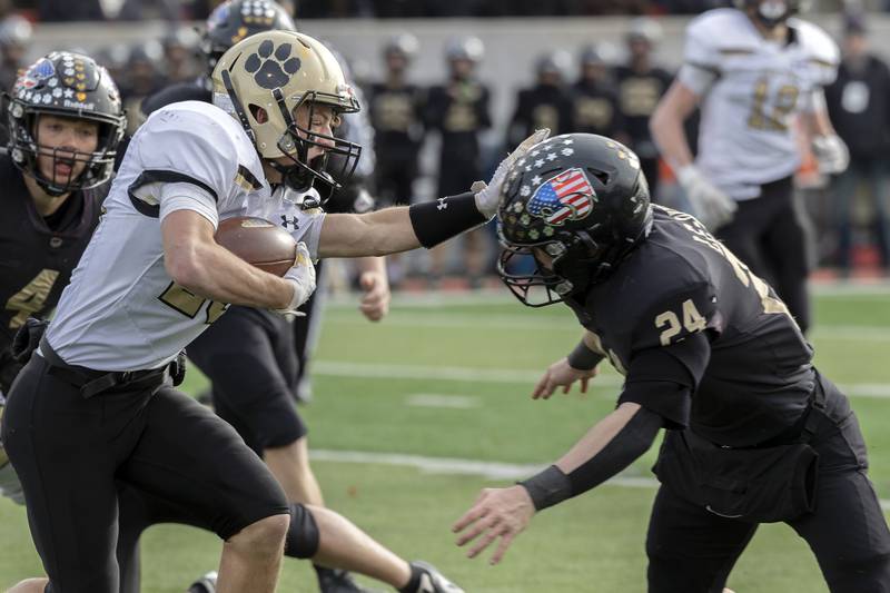 Camp Point's Drew Paben looks for running room against Lena-Winslow's Lucas Fye Friday, Nov. 24, 2023 in the 1A state football championship game at Hancock Stadium in Normal.