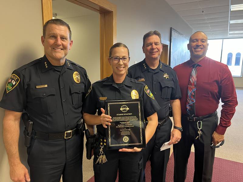 Sycamore Police Chief Jim Winters and Sergeant Stacy Binkowski stand alongside Lemont Police Chief Marc Maton and Illinois Law Enforcement Accreditation Program lead assessor Joel Givens, after Sycamore Police was presented with a tier one accreditation by Maton and Givens during a Sycamore City Council meeting on June 17, 2024.