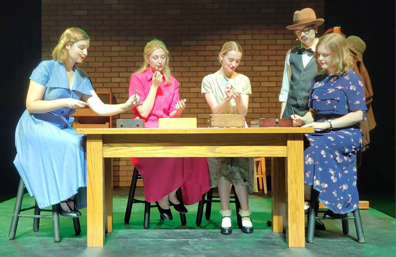 Radium Dial employees Catherine Donahue (played by Sadie Johnson), Charlotte Purcell (Molly Ewen), Pearl Payne (Sarah McGrath) and Frances O'Connell (Ava Wagner) paint their clock faces under the watchful eye of boss Rufus Reed (Tobias Burkey, standing) during Ottawa High School's rendition of "These Shining Lives" slated for this Friday and Saturday in the school auditorium.
