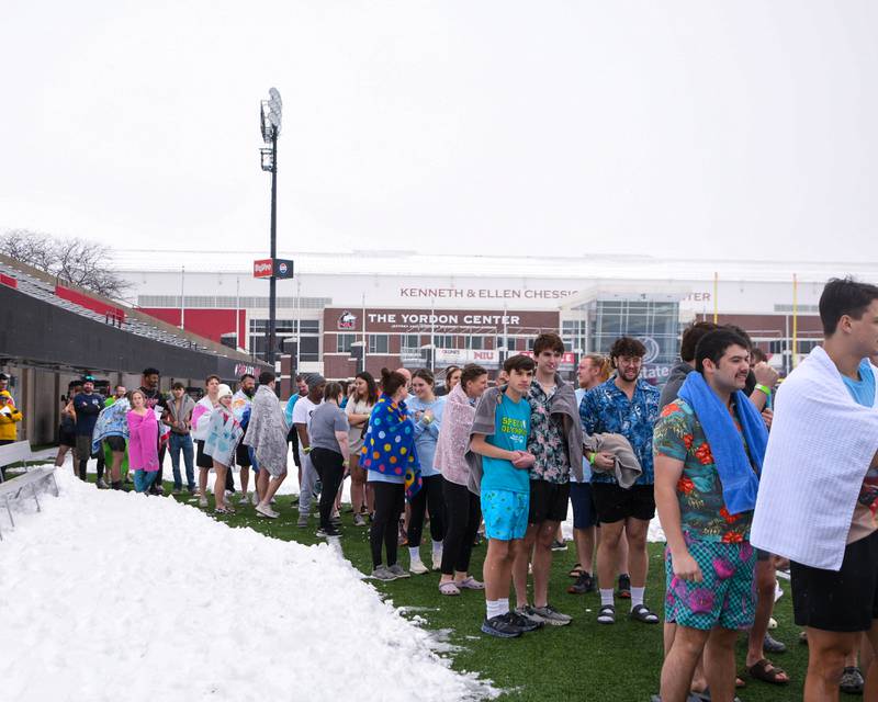 Participants wait to take their turns jumping into a cold pool on Saturday, Feb. 15, 2025, during the 2nd annual Polar Plunge at Northern Illinois University's Huskie Stadium in DeKalb. Proceeds benefiting the law enforcement torch run for Special Olympics.