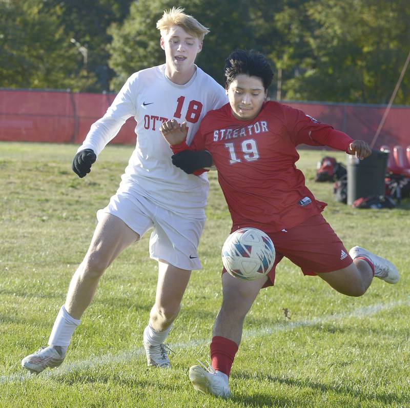 Ottawa’s Robert Polier and Streator’s Jordy Sanchez fight for control of the ball in the 1st half Tuesday at Streator.
