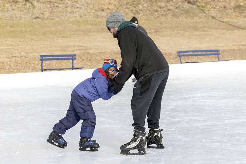 Harper Ruiz, 6, gets a hand from dad Kyle during her first go on ice skates Saturday, Jan. 11, 2025, in Dixon. The rink opened late Friday and will be offering free skate rentals from 2-5 p.m. Monday, Tuesday and Wednesday.