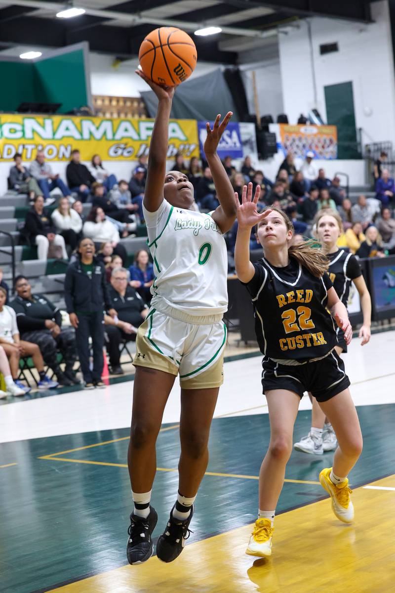 Bishop McNamara's Mahlyia Johnson shoots a layup past Reed-Custer's Avah Thompson during Bishop McNamara's 60-36 victory over Reed-Custer in the IHSA Class 2A Bishop McNamara Regional semifinals on Monday, Feb. 16, 2026.