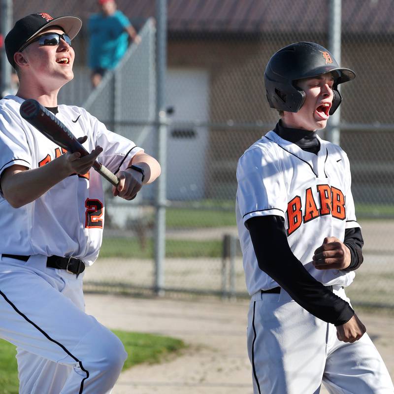 DeKalb's Jackson Kees (right) is fired up after scoring a run during their game against Naperville Central Tuesday, April 30, 2024, at DeKalb High School.