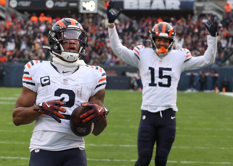 Chicago Bears wide receiver DJ Moore scores a touchdown as teammate Rome Odunze looks on during their game against the Minnesota Vikings Sunday, Nov. 24, 2024, at Soldier Field in Chicago.
