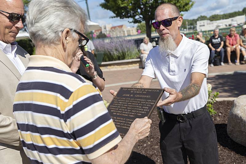 Clayton Beach presents John Groshans Friday, Aug. 9, 2024 with a duplicate plaque of what is being affixed at the Dixon riverfront. Groshans has dedicated many hours to the upkeep and beautification of Heritage Crossing.