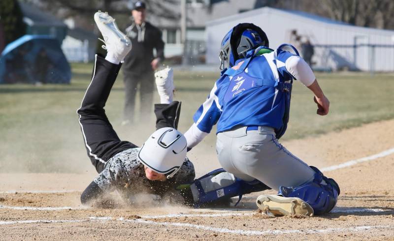 Rock Falls' Owen Mandrell slides in under the tag of Princeton catcher Ace Christiansen to score a first-inning run Thursday at Prather Field. The host Tigers won 5-4.
