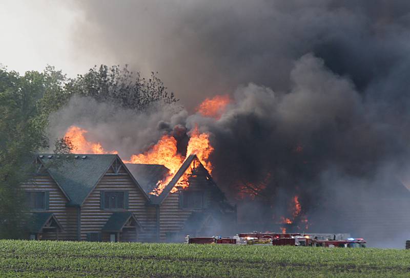 Large flames engulf several cabins at Grand Bear Resort on Monday, May 30, 2022. High winds made it extremely difficult for firefighters to battle the flames.