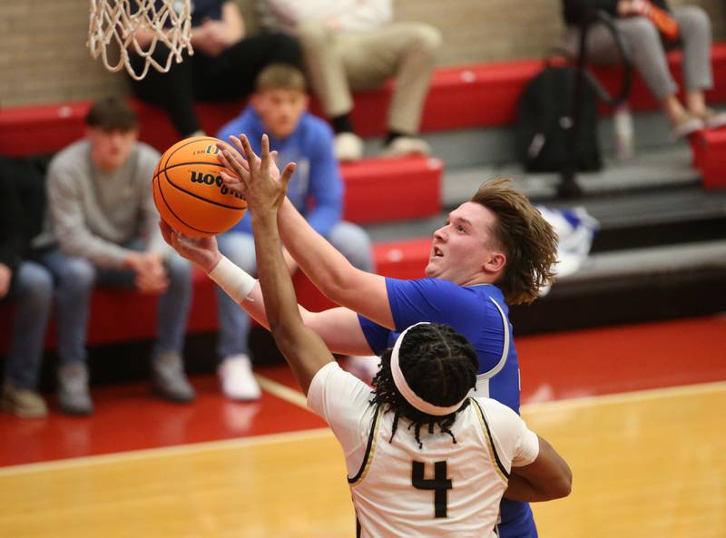 Princeton's Jordan Reinhardt eyes the hoop as Oak Forest's Kyan Owokoniran defends during the Dean Riley Shootin' The Rock Thanksgiving Tournament on Tuesday, Nov. 26, 2024 in Kingman Gym at Ottawa High School.