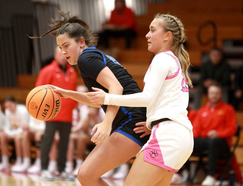 St. Charles North’s Riley Barber tries to get around Batavia’s Samantha Jansey during a game on Monday, Dec. 16, 2024 in Batavia.