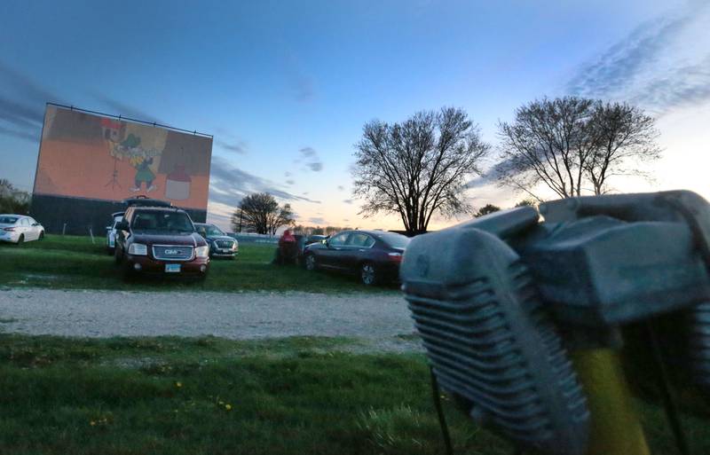 The sun sets over the Route 34 Drive-in on Friday, April 19, 2024 in Earlville. The Drive-In theater opened for the season this weekend.