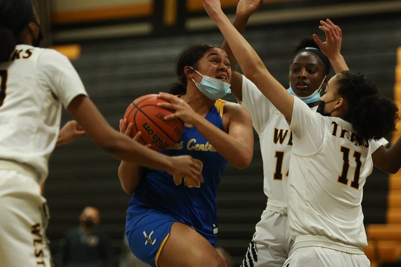 Joliet Central’s Joyce Tua-Link battles to the basket against Joliet West. Tuesday, Feb. 8, 2022, in Joliet.