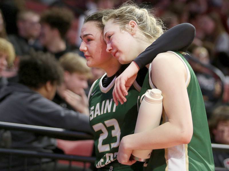 St. Bede's Ali Bosnich hugs teammate Ashlyn Ehm as they walk off of the floor after loosing to Altamont 64-56 in the Class 1A third-place game on Thursday, Feb. 29, 2024 at CEFCU Arena in Normal.