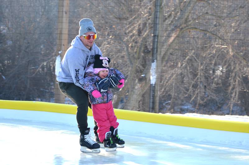 Jeremy Majeski and his daughter Mila, 3, of Morrison, enjoyed skating on the new ice rink during the Morrison Winter Park grand opening on Tuesday, Dec. 27. The winter warm spell may limit activities until snow returns, but Water Works Park will be open for winter recreation during regular park hours of 7 a.m. to 10 p.m.