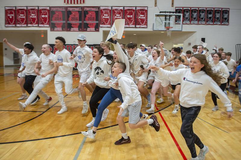 Newman students storm the court after the Comets beat River Ridge in straight sets to take the sectional championship Wednesday, Nov. 2, 2022.