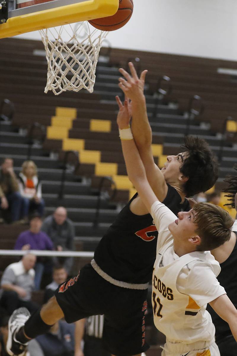 McHenry's Marko Visnjevac tries to grab a rebound over Jacobs' Carter Roper during a Fox Valley Conference basketball game Wednesday, Dec. 7, 2022, between Jacobs and McHenry at Jacobs High School in Algonquin.