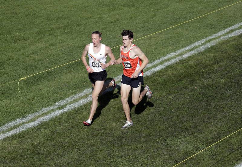 St. Charles East's Micah Wilson and Dekalb's Riley Newport lead the pack at the start of the boys race during the Lake Park IHSA Sectional cross country meet Saturday October 30, 2021 in Roselle.