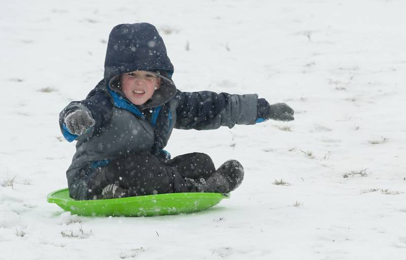 Will Trejo, 8 of St. Charles zooms down the sledding hill at Langum Park in St. Charles during the first snow of the 2021-2022 winter season on Tuesday, December 28, 2021.