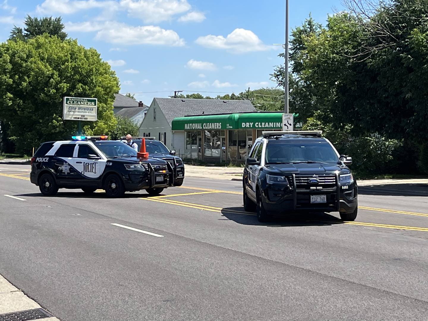 Joliet Police Department squad vehicles near the intersection of Jefferson and Reed streets on Wednesday, Aug. 10, 2022. Officers had responded to a crash involving a motorcycle.