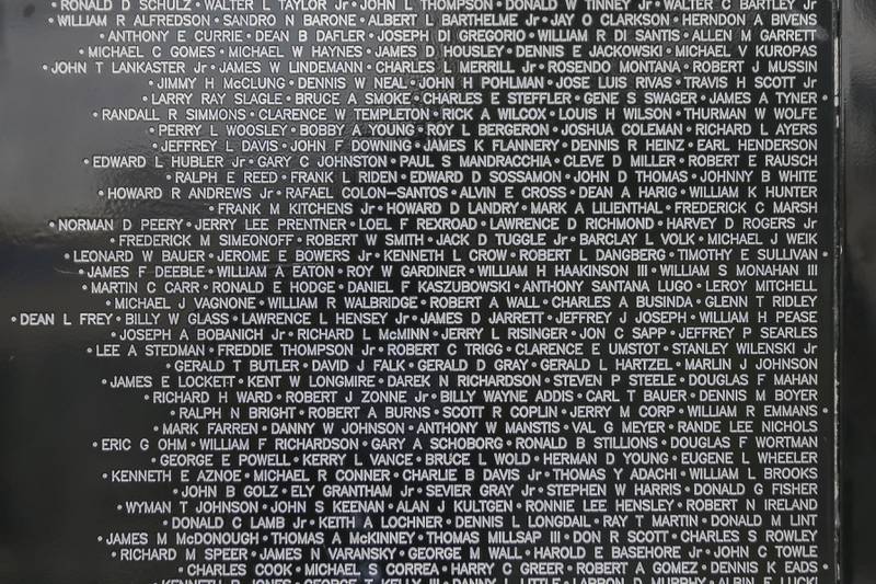 A close up of a section of the Vietnam Traveling Memorial Wall Thursday, Aug 21, 2025  in Romeoville.