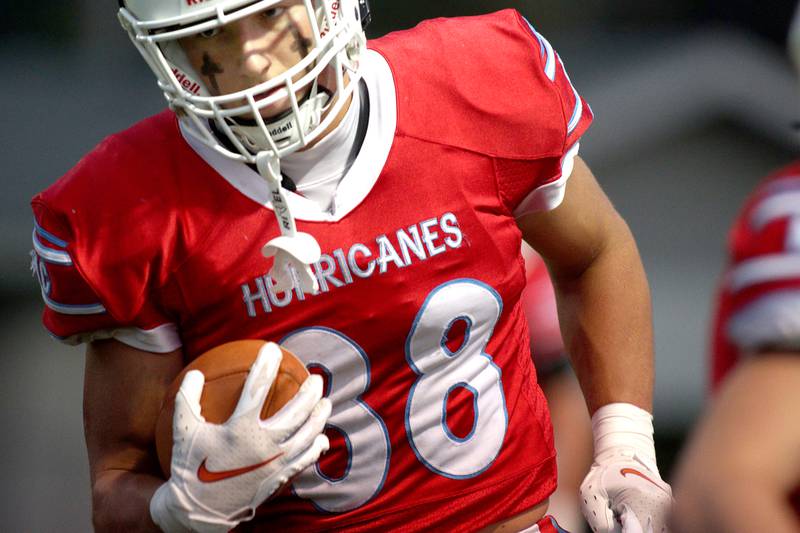 Marian Central’s Christian Bentancur takes warm-ups before facing Chicago Hope in varsity football at Woodstock Friday night.