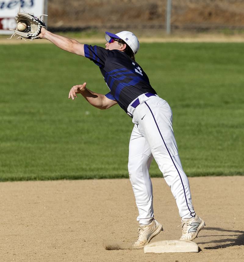 Dixon’s Jake Zepezauer reaches for a throw and keeps his foot on the bag for an out against North Boone Tuesday, May 6, 2025.