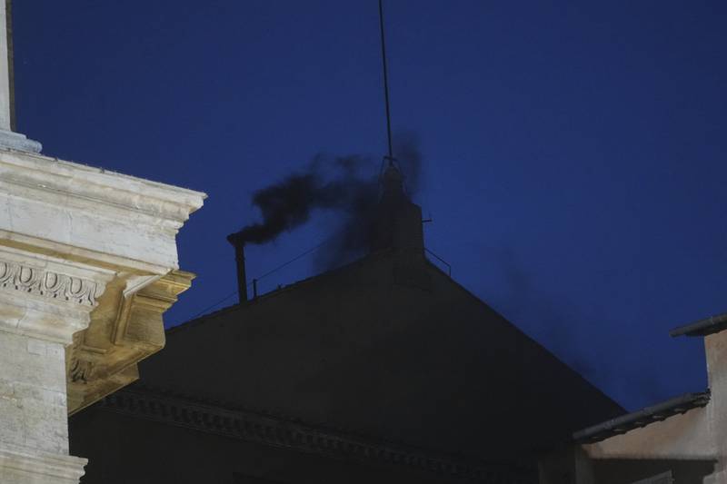 Black smoke billows from the chimney of the Sistine Chapel during the cardinals' conclave to elect a new pope, at the Vatican, Wednesday, May 7, 2025. (AP Photo/Alessandra Tarantino)