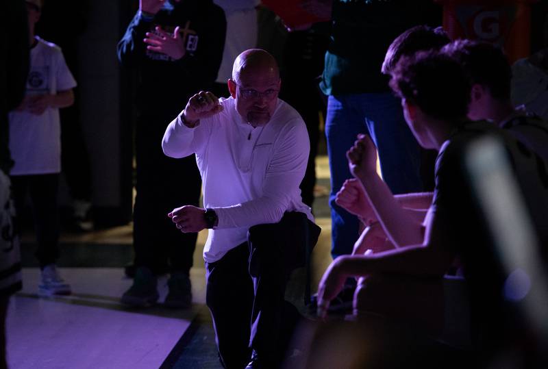 Bishop McNamara's head coach Adrian Provost waits as his players are introduced in a game against Newark on Friday, Feb. 20, 2026.