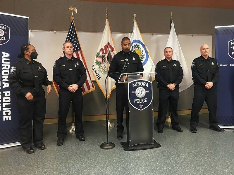 Aurora Police Chief Keith Cross, center, discusses an officer's shooting of a man Sunday in Aurora.