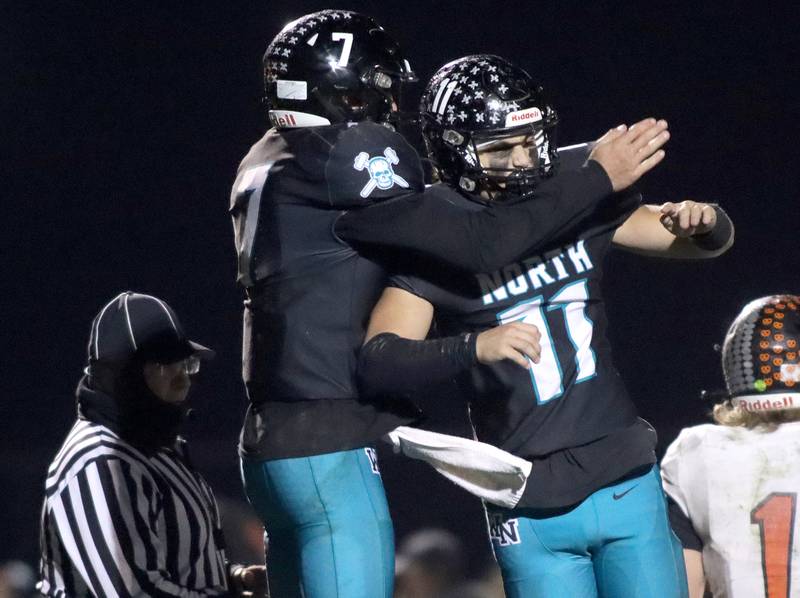 Woodstock North’s Parker Halihan, left, and George Kingos celebrate a Halihan touchdown against Freeport in first-round IHSA Playoff football action on Saturday, Nov. 2, 2024 at Woodstock North High School in Woodstock.
